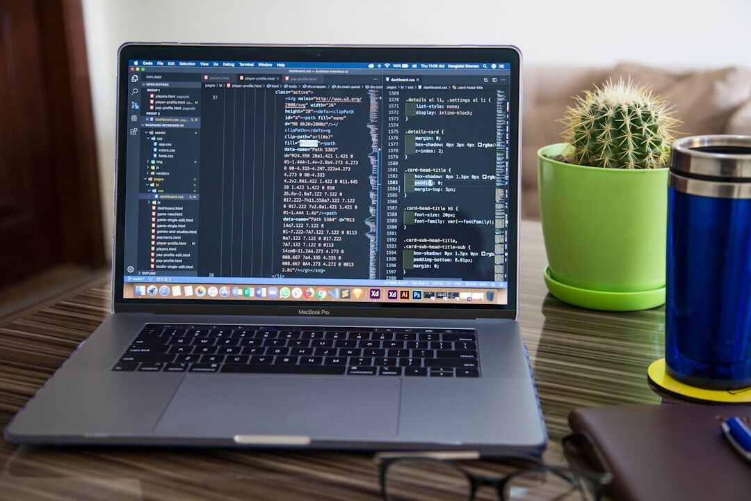 programmer coding on laptop