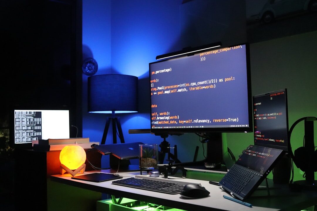 Desk with multiple monitors showing code and a mechanical keyboard