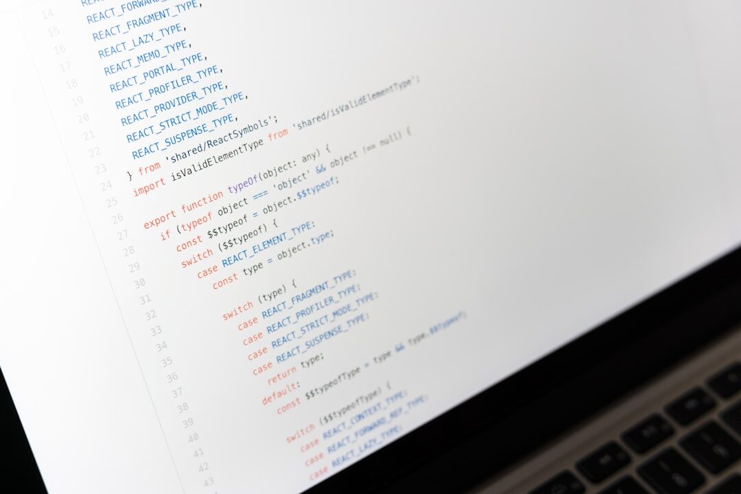 Laptop screen displaying colorful lines of source code