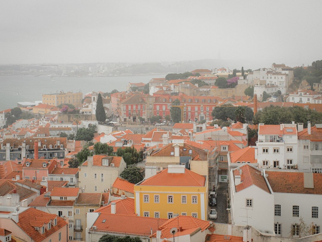 Lisbon rooftops and skyline at dusk with warm lights