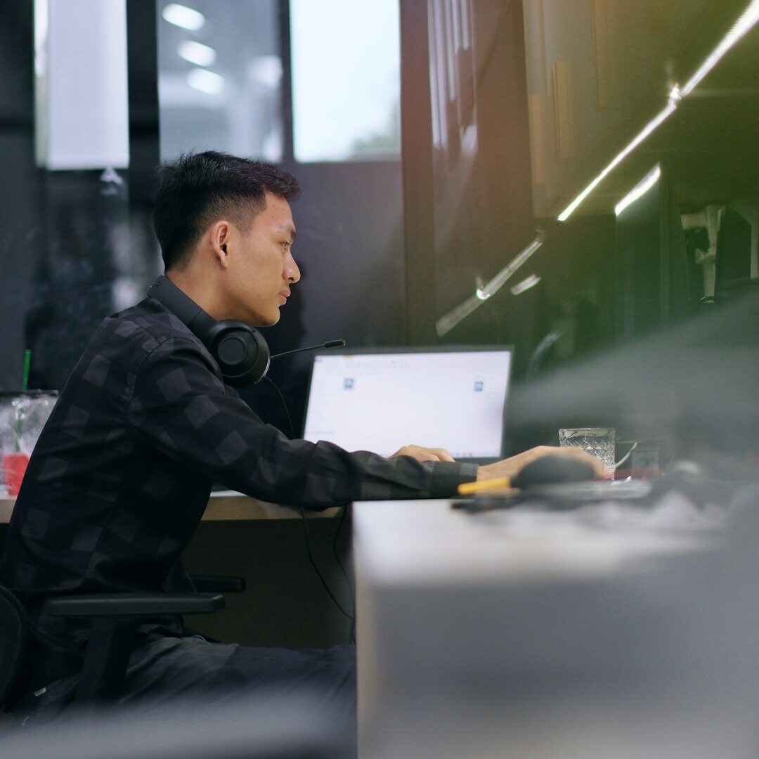 Close-up portrait of a developer typing on a mechanical keyboard