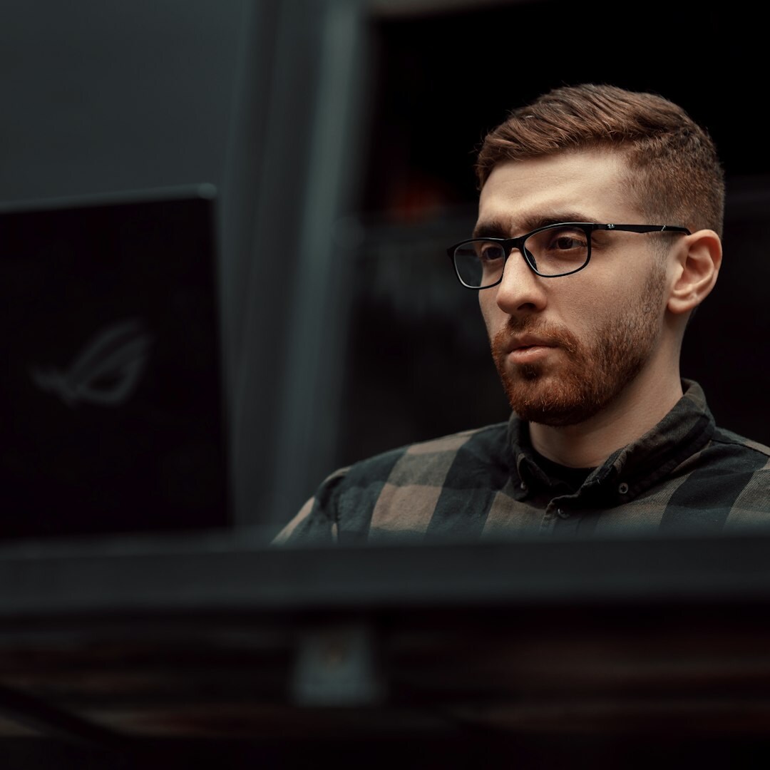 Two developers reviewing code together on a laptop screen